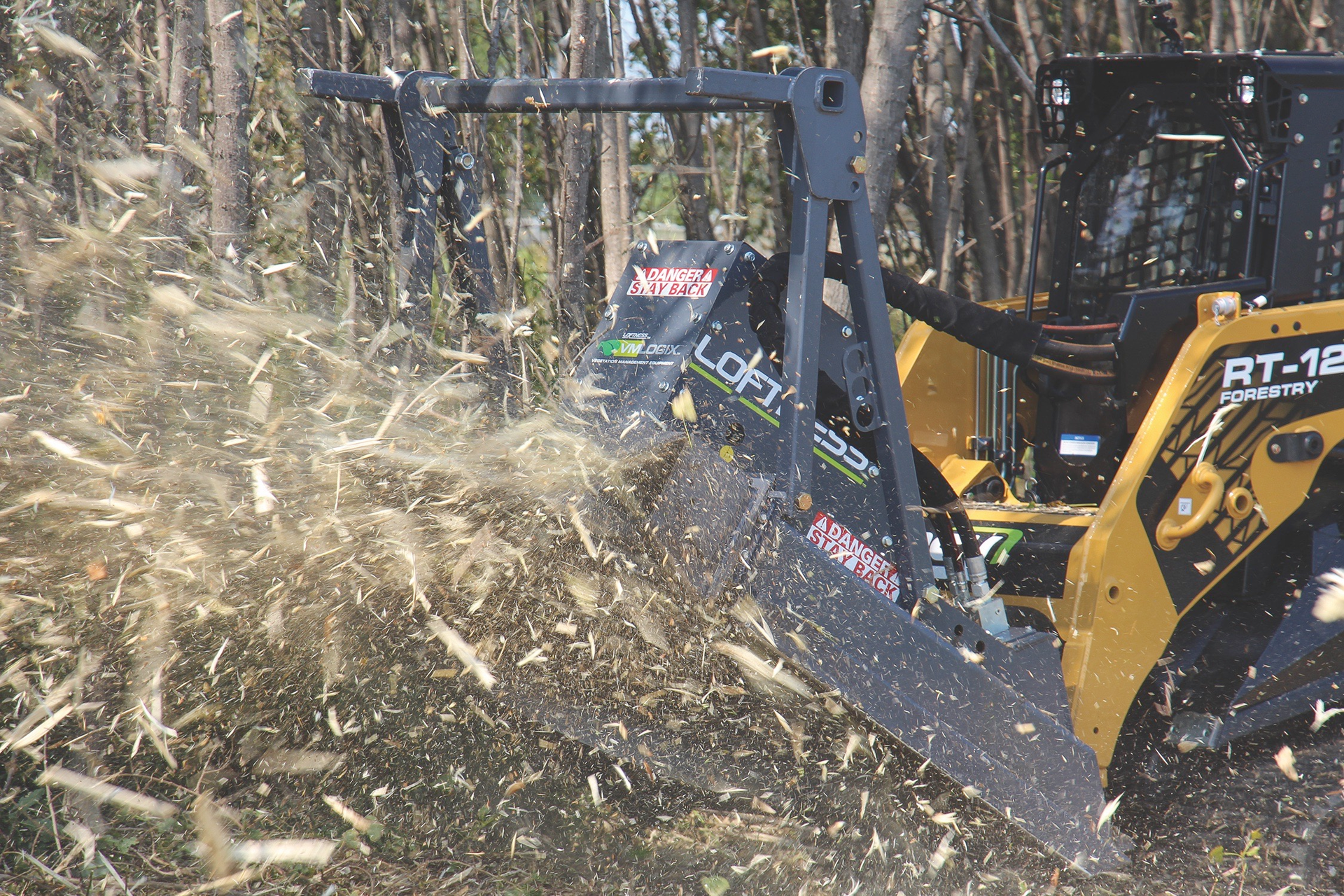 Loftness Bad Ax on compact track loader clearing land